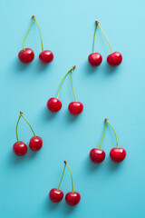 Cherry berries on blue background top view