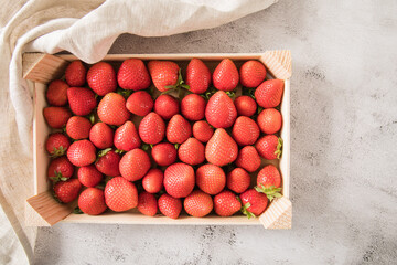 Frische Erdbeeren in Holz Kiste für Lager auf Leinentuch und Marmor Hintergrund hell