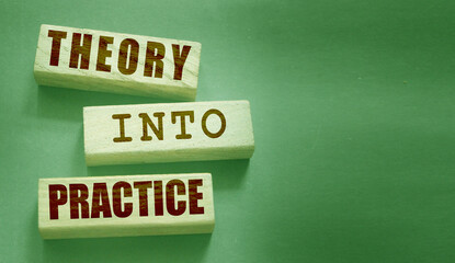 Theory into practice words written on wooden blocks. Education or business startup concept