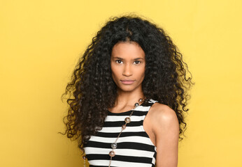 Portrait of a beautiful dominican woman with gorgeous curly long hair - obrazy, fototapety, plakaty