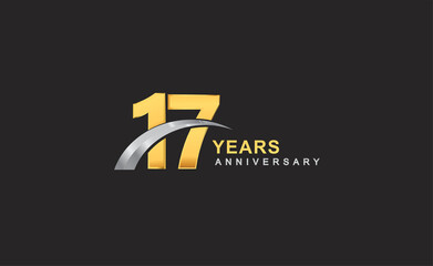 17th years anniversary logo with golden ring and silver swoosh isolated on black background, for birthday and anniversary celebration.