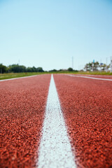 Covering the treadmill in close-up. Marked white lines on the sports field.