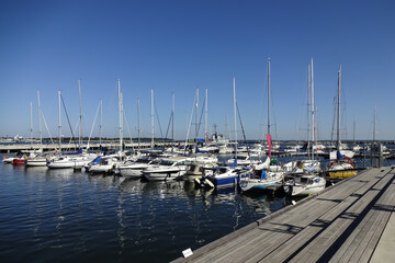 Seaview in the area of Maritime museum in Seaplane Harbour (in Estonian Lennusadam). Yachts and sailing boats on the dock. A sunny summer day with a clear blue sky. Tallinn, Estonia