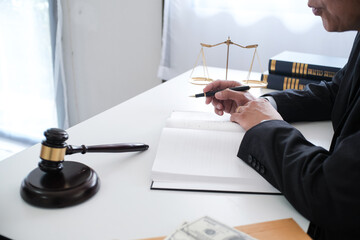 Legal counsel presents to the client a signed contract with gavel and legal law. justice and lawyer...