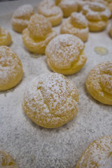 cream puffs aligned closeup isolated on white background.