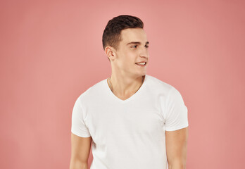 Obraz premium handsome man fun gesture with hands pink background emotions