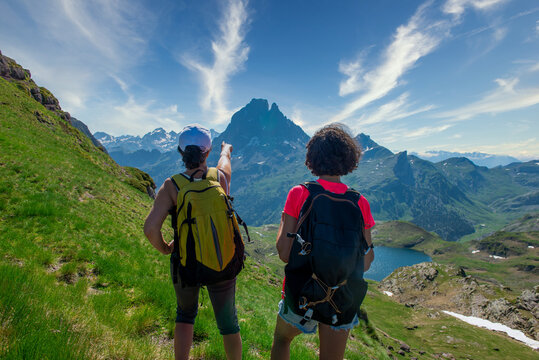 Two hiker women in path of Pic du Midi Ossau in French Pyrenees mountains