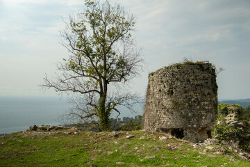 old ruined stone tower on top of mountain.