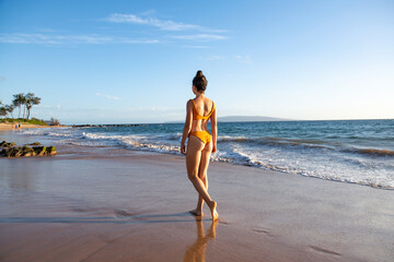 Woman walking on sea shore nature. Meditation divine calm throught. Summer light. Back view.