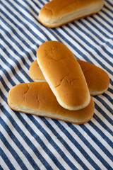 Whole Grain Hot Dog Buns on cloth, side view.