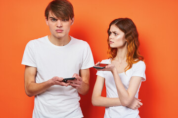 cheerful young couple with phones in hands fashion technology