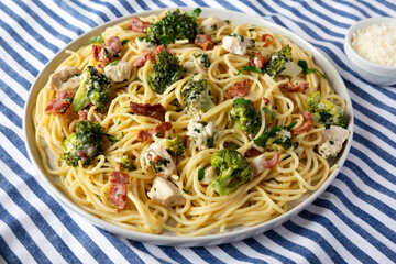 Homemade Chicken Bacon Broccoli Alfredo on a plate, low angle view. Close-up.