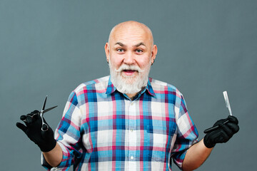 Portrait of stylish man bearded man with grey moustache beard. Old barber with scissors and razor. Vintage barbershop, shaving.