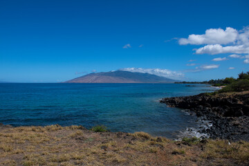 Hawaii beach. Sea view from tropical beach with sunny sky. Summer paradise beach of hawaii island. Tropical shore. Exotic summer beach with clouds. Ocean calm and relax.