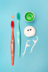 Teeth hygiene and oral dental care products. Morning concept. Dental floss. Vertical. Blue background. Oral Care Set.