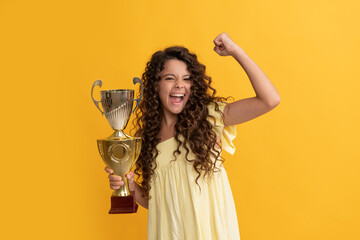 happy teen girl hold golden cup. achievement award. celebrating success and victory.