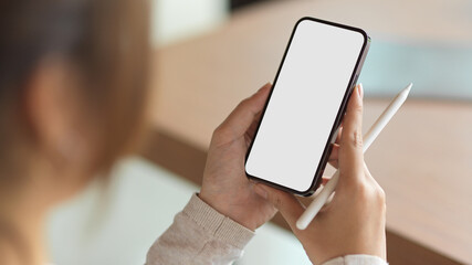 A girl using smartphone with holding stylus pen
