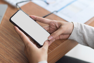Mock up blank mobile screen by holding with 2 hands