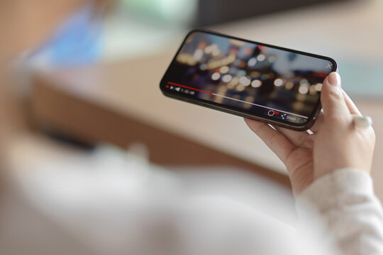 Female Watching Bokeh Video On Smartphone With Blur Background