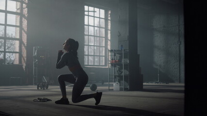 Fototapeta premium Woman doing frontal squats with lunges. Girl squatting during physical exercises