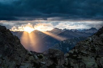 Dark clouds during a dramatic sunset in the European Alps.