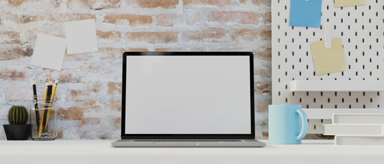 Laptop mock-up on white table decorated with stationery, and brick wall, Office loft room concept design, 3D illustration