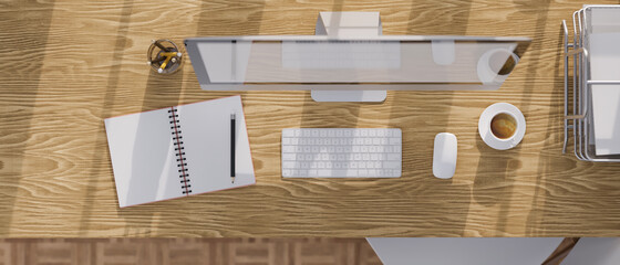 Top view of wooden study table with desktop computer, stationery and office paper tray