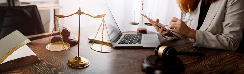 Justice and law concept.Male judge in a courtroom with the gavel, working with, computer and...