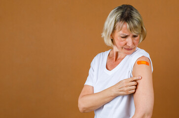 Portrait Closeup studio shot of Caucasian senior blonde female patient stand stressing has pain...