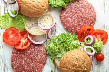 Concept of cooking burger on white wooden table