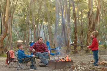 Naklejka na ściany i meble Kids with father burning campfire at Kuitpo forest camping ground school holidays in South Australia