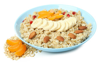 Bowl of oatmeal with tasty ingredients isolated on white background