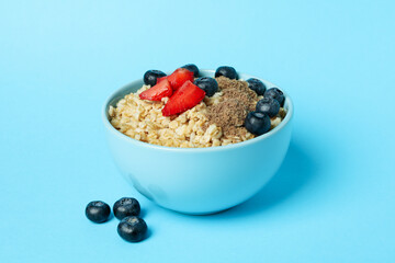 Concept of tasty eating with oatmeal on blue background