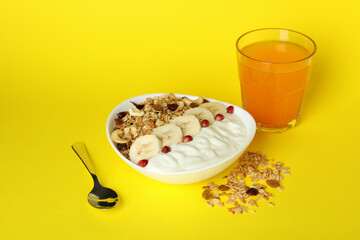 Concept of tasty eating with oatmeal on yellow background