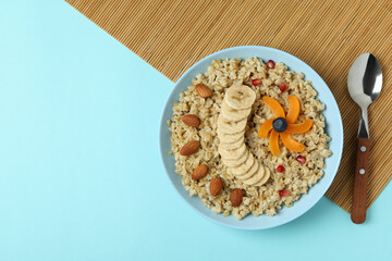Concept of tasty eating with oatmeal on blue background