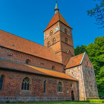 Alexander church in Wildeshausen with green trees and blue sky