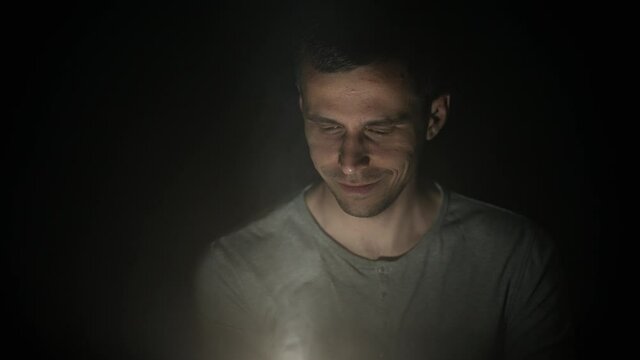 Man looking at something glowing