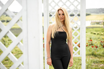 Blonde woman on a dry grass