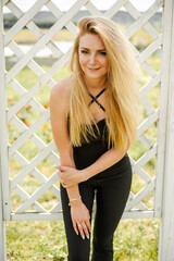 Blonde woman on the garden field in the summer