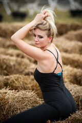 Blonde woman on a dry grass