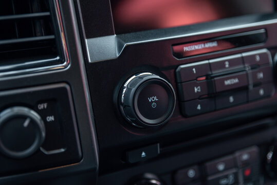 Car radio front volume close-up. Modern car audio system. Car radio controls.