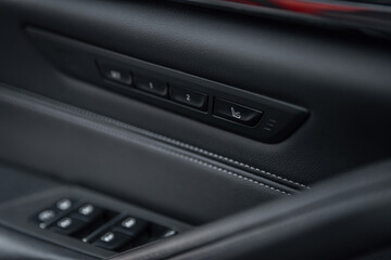 Obraz na płótnie Canvas Car seat massage control panel. Massagers button. Close-up of the luxury car black interior.