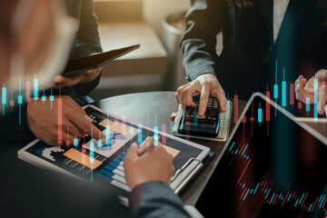 Business team working with holding a pen and using a calculator to calculate the numbers of static at home office. Finance accounting concept.