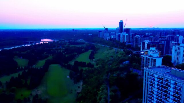 White Pink Blue Sunset aerial flyover luxury residential high rises at the River Valley Victoria Park Golf Course in Downtown Edmonton Alberta CDN close to the Saskatchewan Crestview Tower Condo 1-7