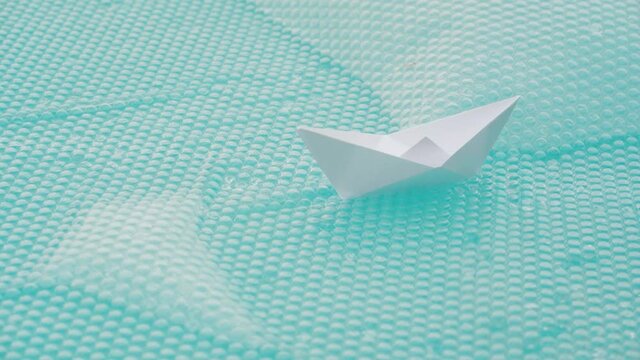 Paper Boat On The Water In The Swimming Pool - high angle, closeup