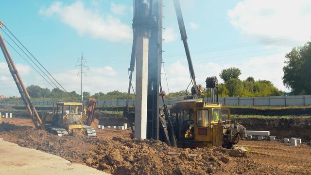 Installation of piles for the foundation of the building. Special equipment and technologies. The pillar is screwed into the ground with the help of a special machine. High quality.
