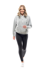 Happy young woman in gray sweatshirt and leggings walking towards camera. Full body isolated on...