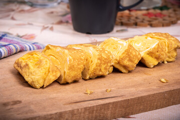 Japanese omelet tamagoyaki pieces on wooden board, close-up