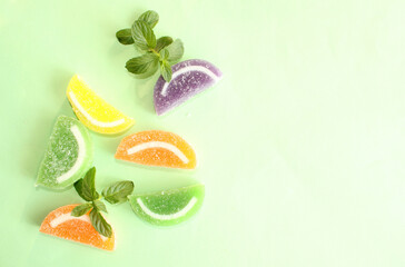 fruit jelly candies mix on color background, top view