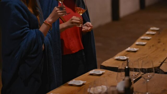 Old winery traditions of Georgia women degust white wine